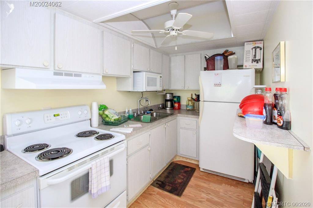 2950 Southeast Ocean Boulevard, Unit 101 Stuart, FL 34996 - Photo 29 of 29 a kitchen with a stove a refrigerator and a sink