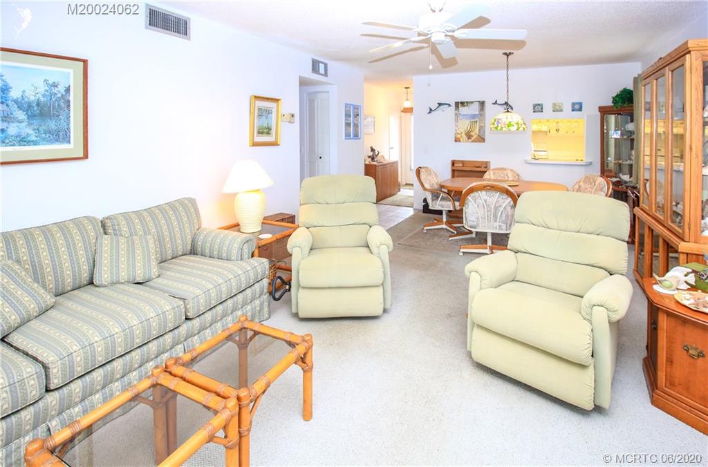 2950 Southeast Ocean Boulevard, Unit 101 Stuart, FL 34996 - Photo 7 of 29 a living room with furniture and a large window