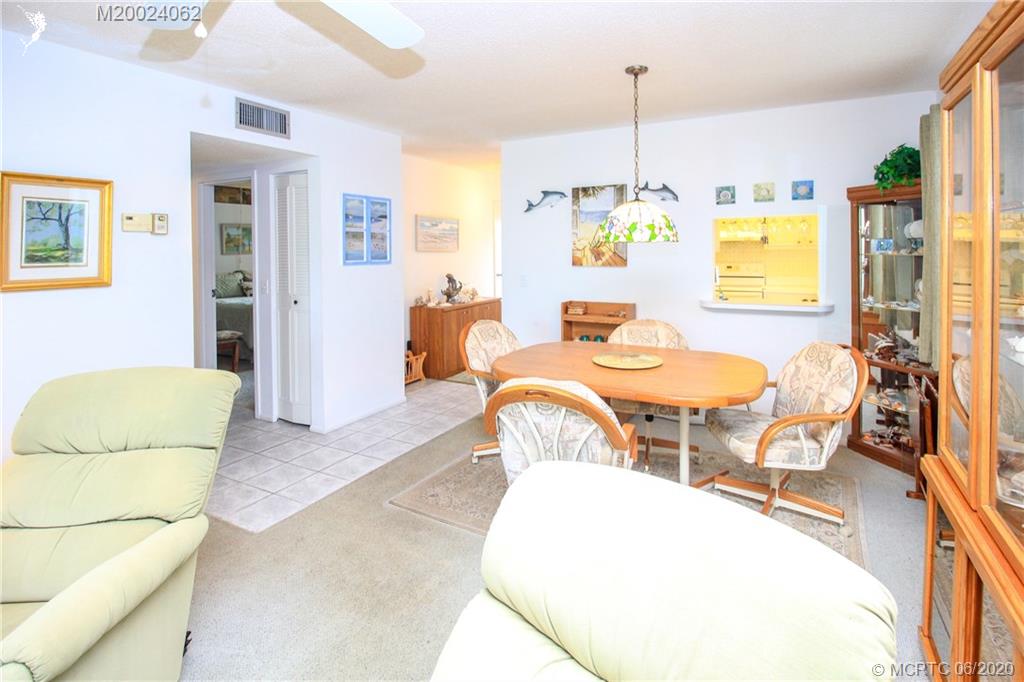 2950 Southeast Ocean Boulevard, Unit 101 Stuart, FL 34996 - Photo 8 of 29 a dining room with furniture and a window