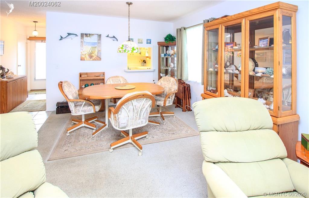 2950 Southeast Ocean Boulevard, Unit 101 Stuart, FL 34996 - Photo 9 of 29 a view of a dining room with furniture and a chandelier