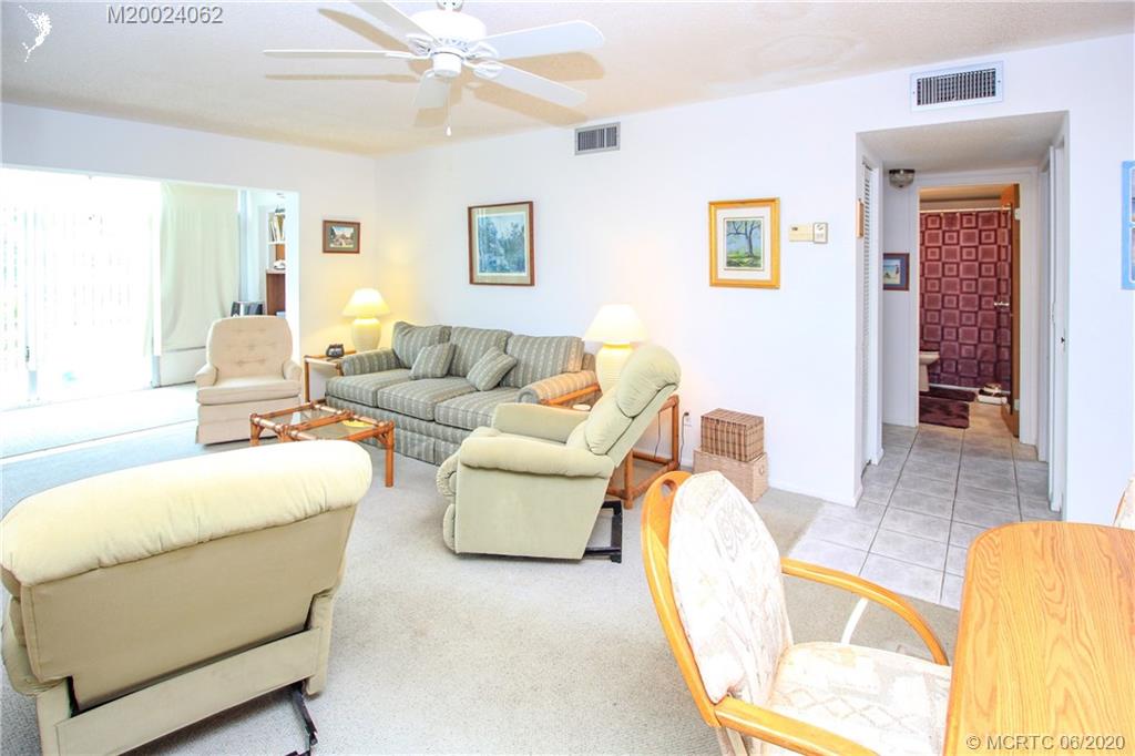 2950 Southeast Ocean Boulevard, Unit 101 Stuart, FL 34996 - Photo 10 of 29 a living room with furniture and a large window