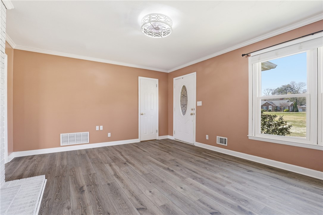 4304 Old Buncombe Road Greenville, SC 29617 - Photo 6 of 49 This bright living area features resilient flooring and ample natural light.