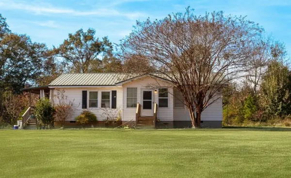 a front view of house with yard and green space