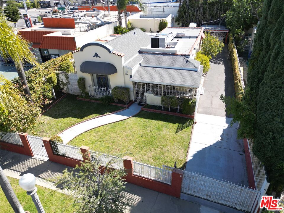 an aerial view of a house with swimming pool and porch