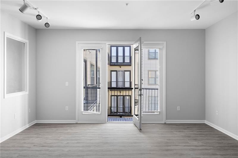 5300 Peachtree Road, Unit 2309 Chamblee, GA 30341 - Photo 13 of 44 an empty room with wooden floor and windows