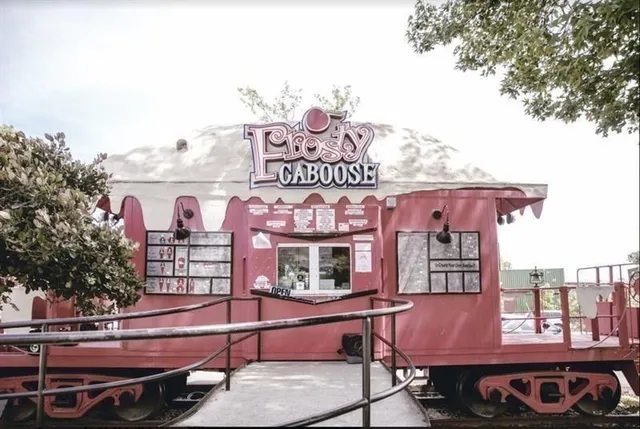 a front view of a building with sitting area