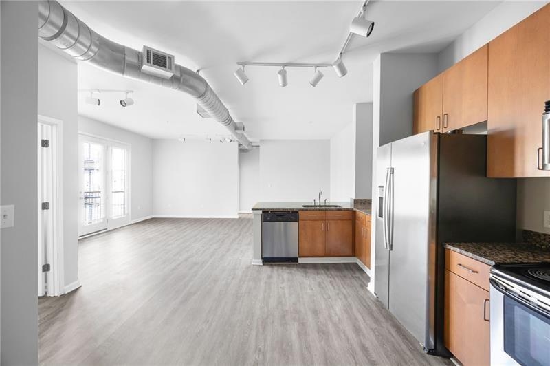 5300 Peachtree Road, Unit 2309 Chamblee, GA 30341 - Photo 8 of 44 a kitchen with stainless steel appliances a refrigerator and wooden floor