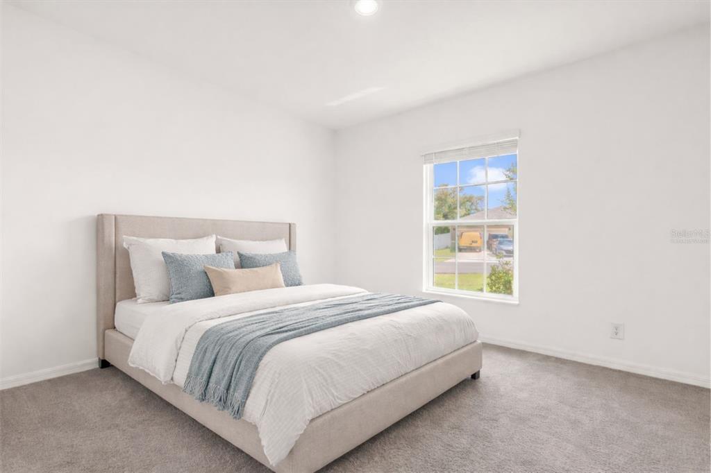 2134 Rio Grande Canyon Loop Poinciana, FL 34759 - Photo 10 of 22 a bedroom with a bed and a window