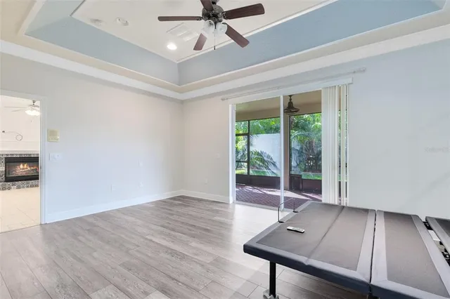 a view of room with wooden floor and fan