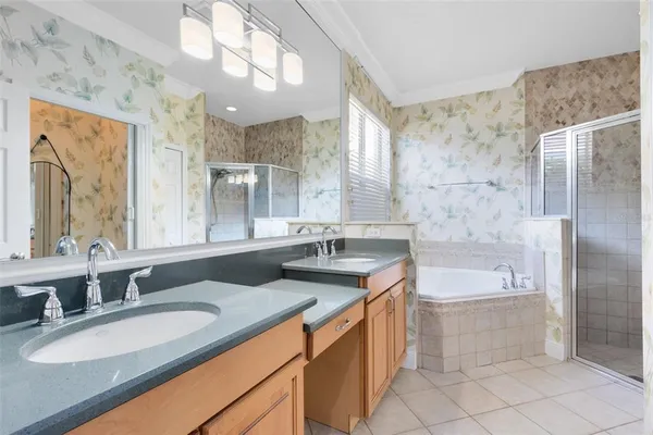 a bathroom with a granite countertop sink a large mirror and a bathtub