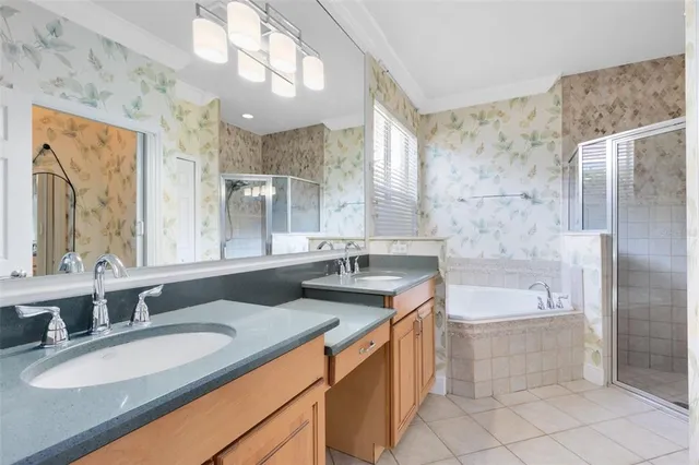 a bathroom with a granite countertop sink a large mirror and a bathtub