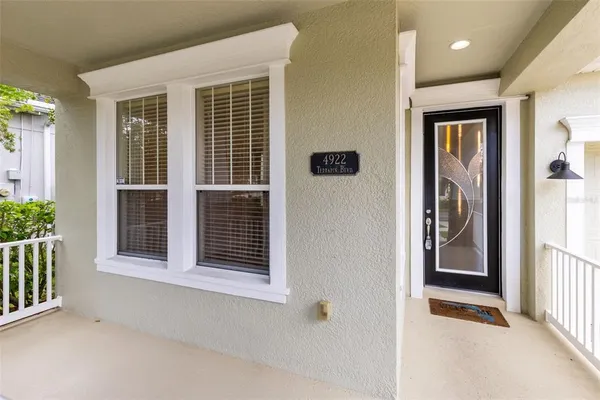 a view of a livingroom with a flesh screen tv and deck