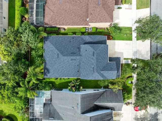 an aerial view of a house with a yard and plants