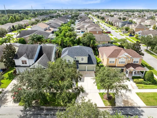 an aerial view of multiple houses with a yard