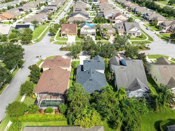 an aerial view of residential houses with outdoor space and street view