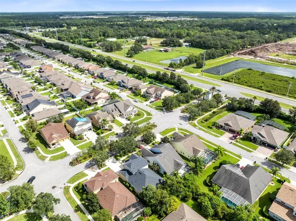 an aerial view of residential houses with outdoor space