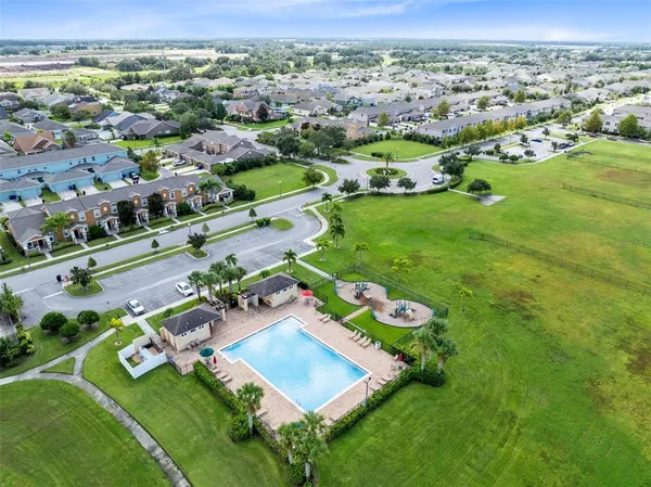 an aerial view of residential houses with outdoor space and street view