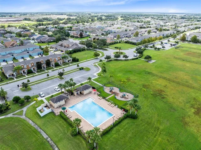 an aerial view of residential houses with outdoor space and street view