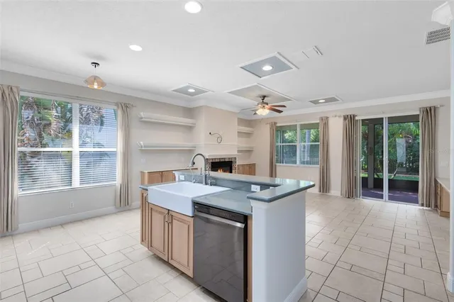 a kitchen with a stove sink and cabinets