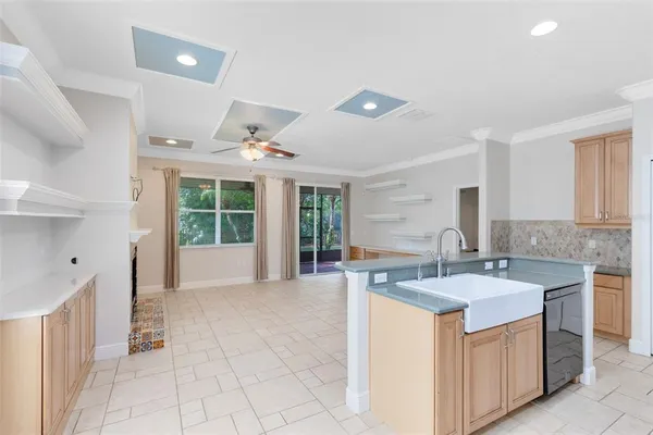 a large white kitchen with a large window