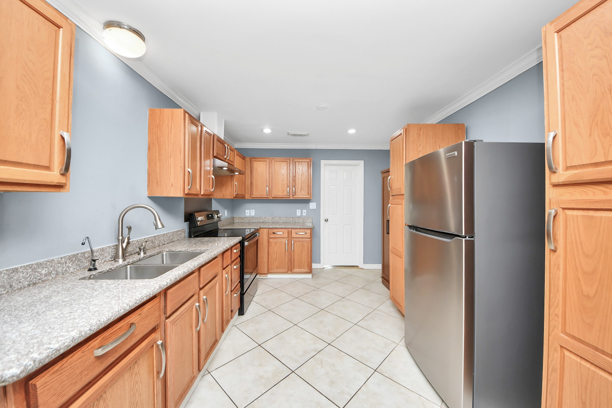 5920 Conley Street Houston, TX 77021 - Photo 18 of 38 a kitchen with stainless steel appliances granite countertop a refrigerator sink and white cabinets