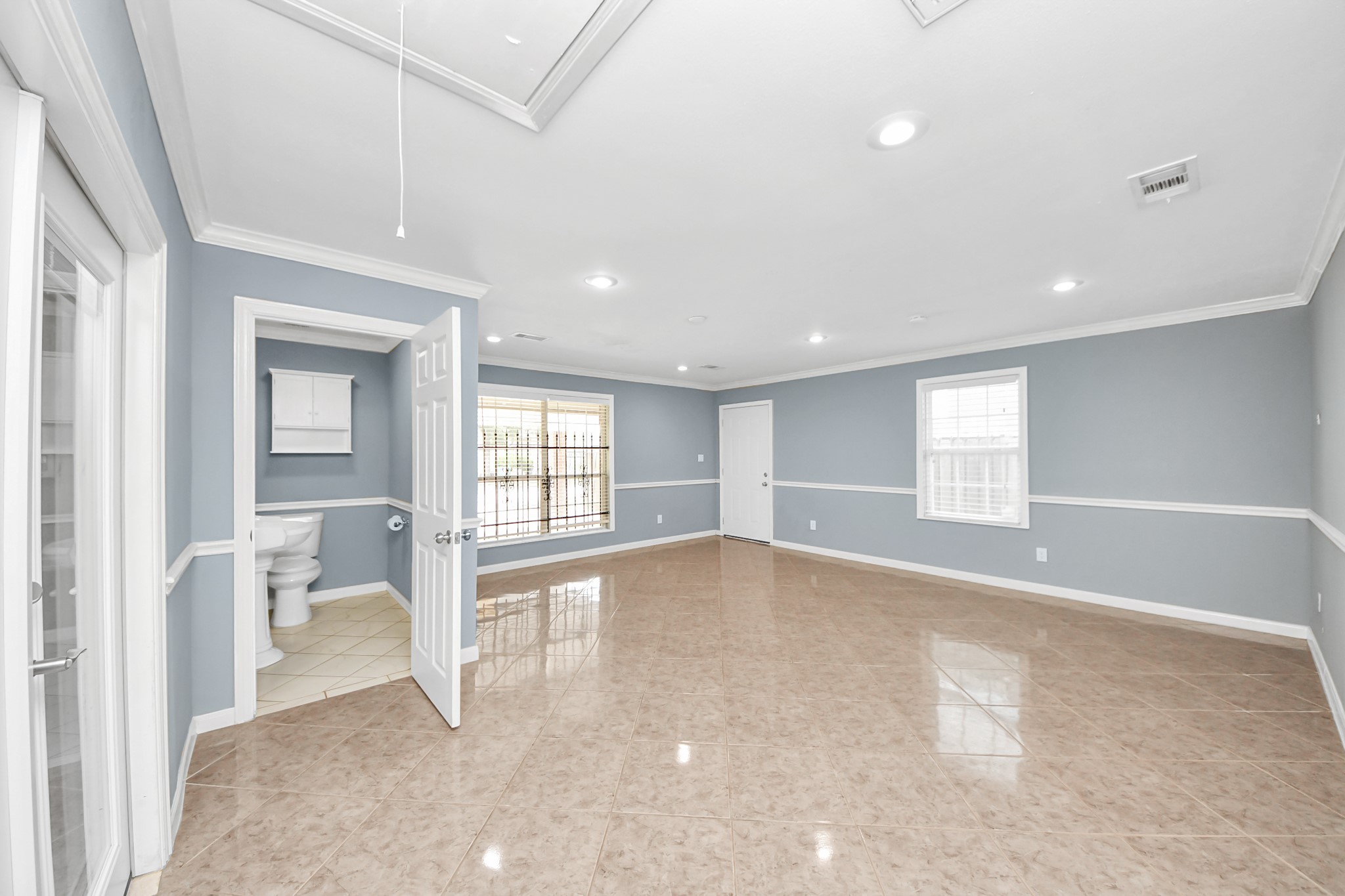 5920 Conley Street Houston, TX 77021 - Photo 6 of 38 a view of an empty room with a window and wooden floor