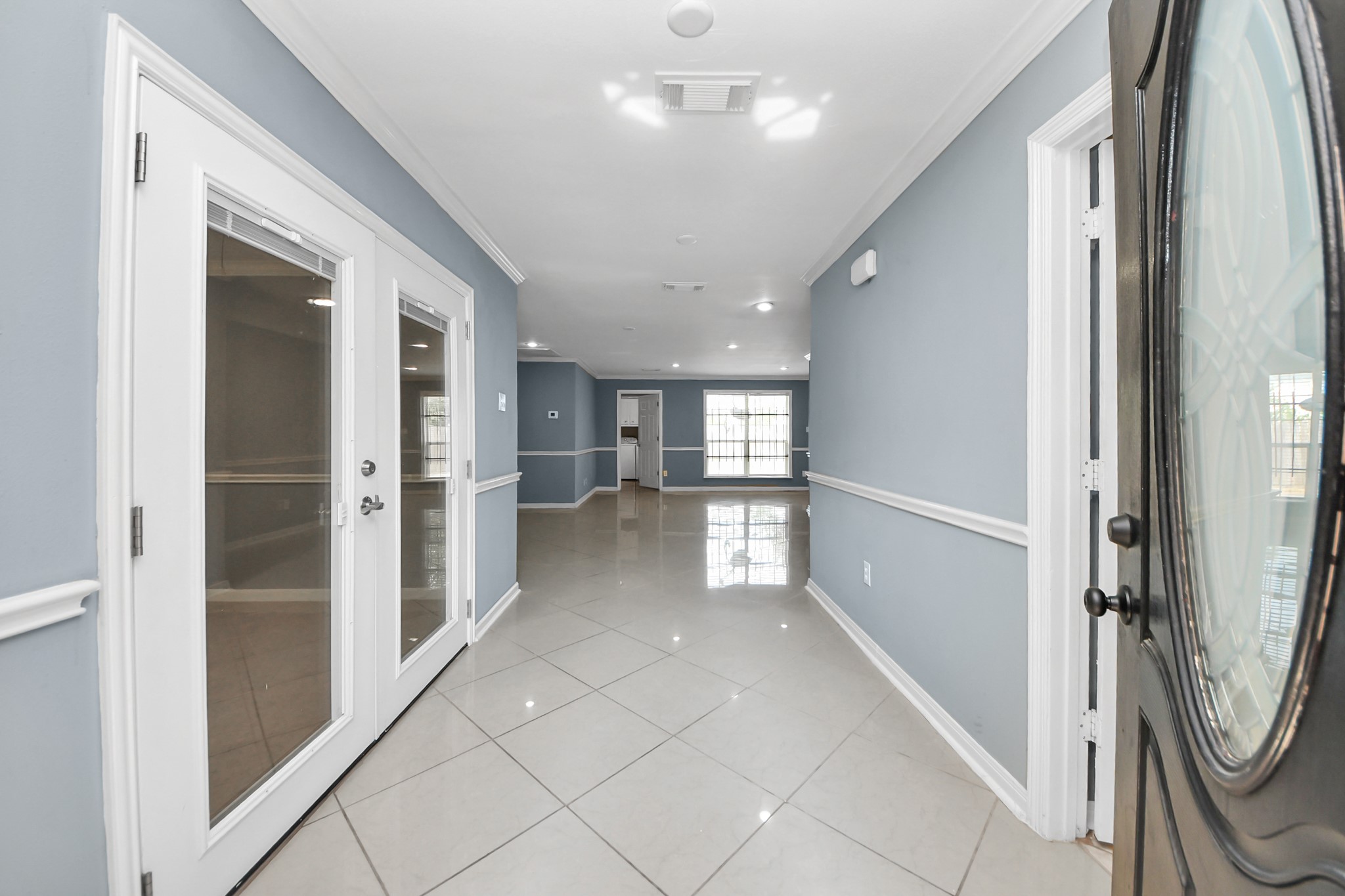 5920 Conley Street Houston, TX 77021 - Photo 10 of 38 a view of a hallway with wooden cabinet and a kitchen