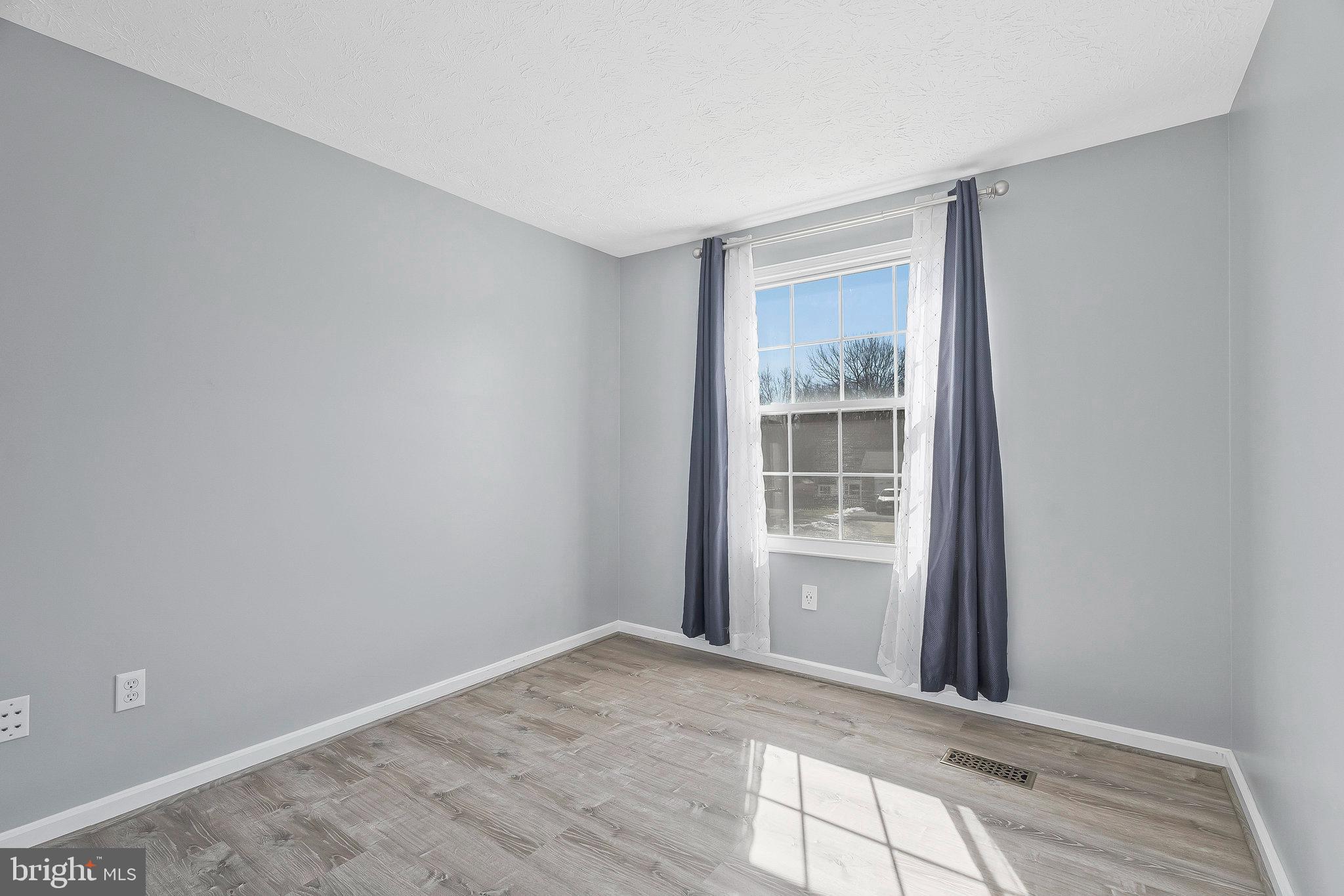4522 Cub Run Road Chantilly, VA 20151 - Photo 11 of 19 a view of an empty room with wooden floor and a window
