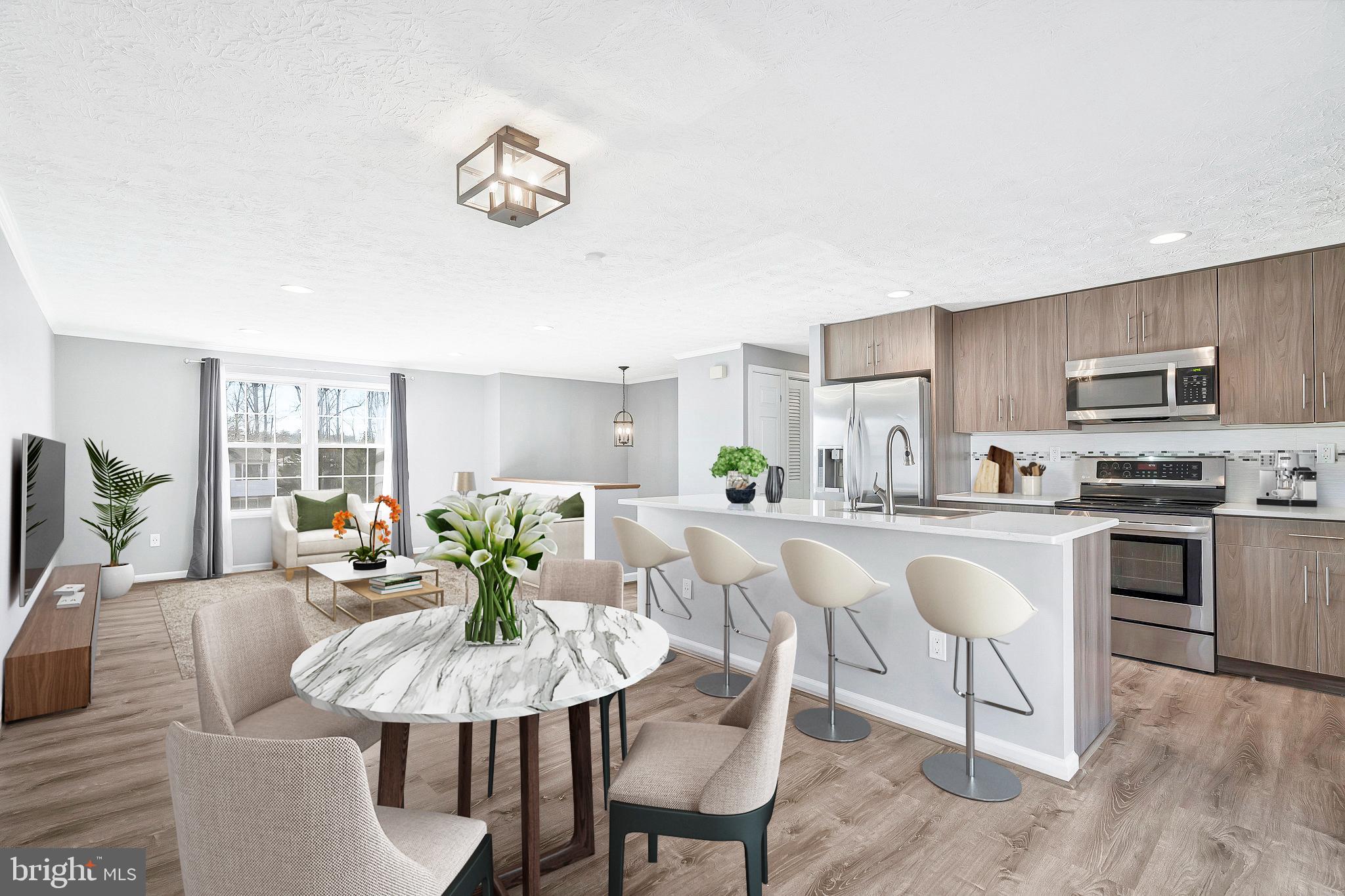 4522 Cub Run Road Chantilly, VA 20151 - Photo 3 of 19 a view of a dining room with furniture a kitchen and chandelier