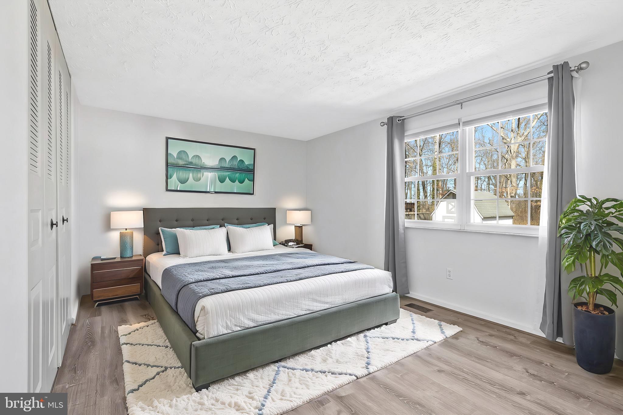 4522 Cub Run Road Chantilly, VA 20151 - Photo 5 of 19 a bedroom with a bed painting and wooden floor