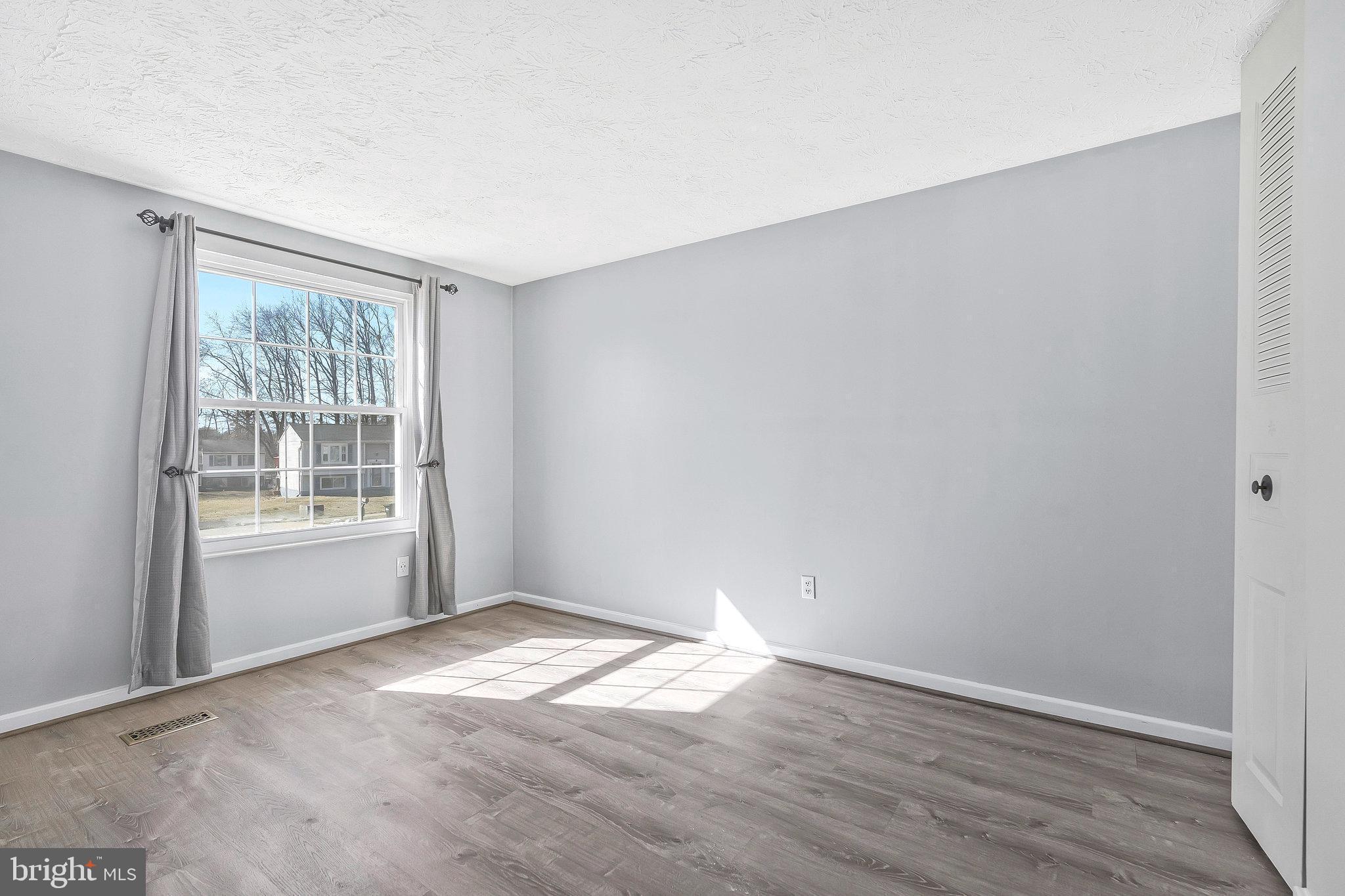 4522 Cub Run Road Chantilly, VA 20151 - Photo 10 of 19 an empty room with wooden floor and windows