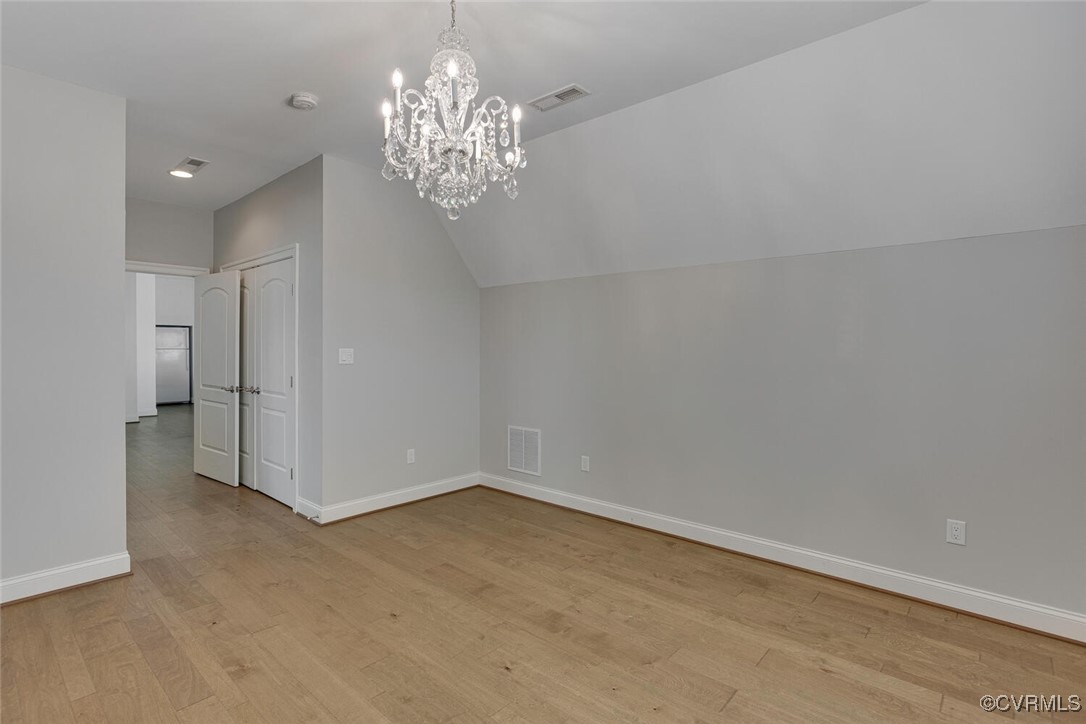 2392 Bel Crest Circle Midlothian, VA 23113 - Photo 31 of 50 wooden floor in an empty room with a chandelier