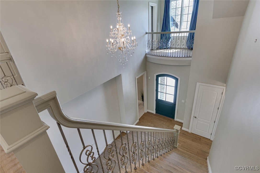 2392 Bel Crest Circle Midlothian, VA 23113 - Photo 6 of 50 a view of a hallway with wooden floor and staircase
