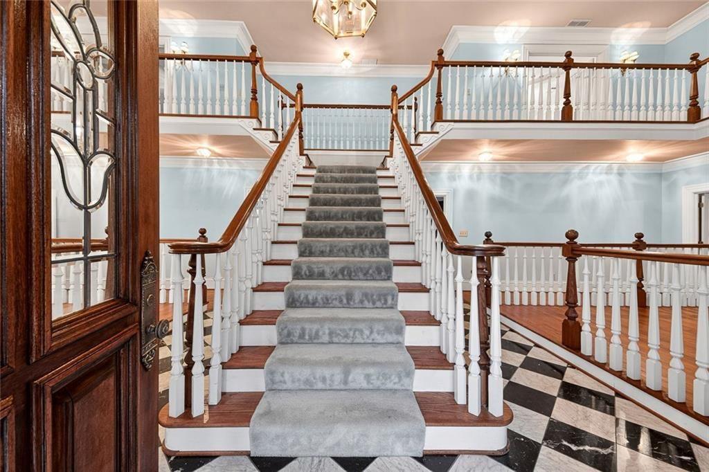 5523 Bahia Mar Circle Smoke Rise, GA 30087 - Photo 12 of 69 a view of staircase with lots of frames on wall and windows