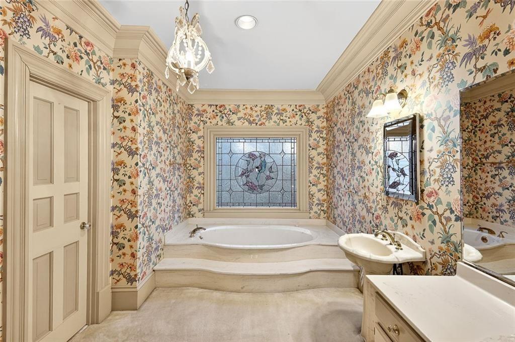 5523 Bahia Mar Circle Smoke Rise, GA 30087 - Photo 30 of 69 a spacious bathroom with a bathtub and shower