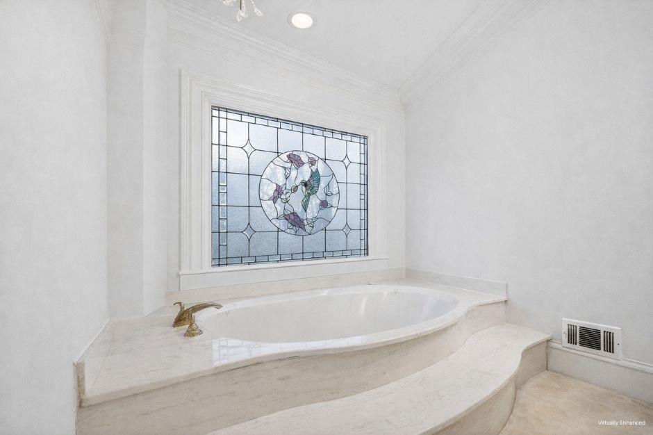 5523 Bahia Mar Circle Smoke Rise, GA 30087 - Photo 32 of 69 a white bath tub sitting in a bathroom next to a window