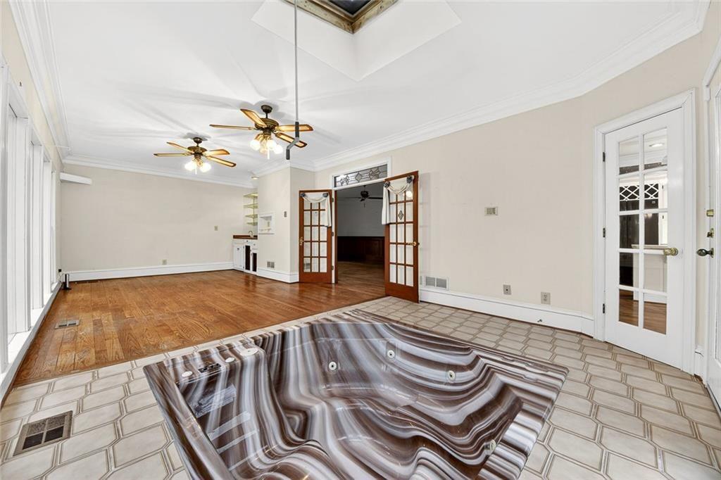 5523 Bahia Mar Circle Smoke Rise, GA 30087 - Photo 40 of 69 a bedroom with a bed and a chandelier