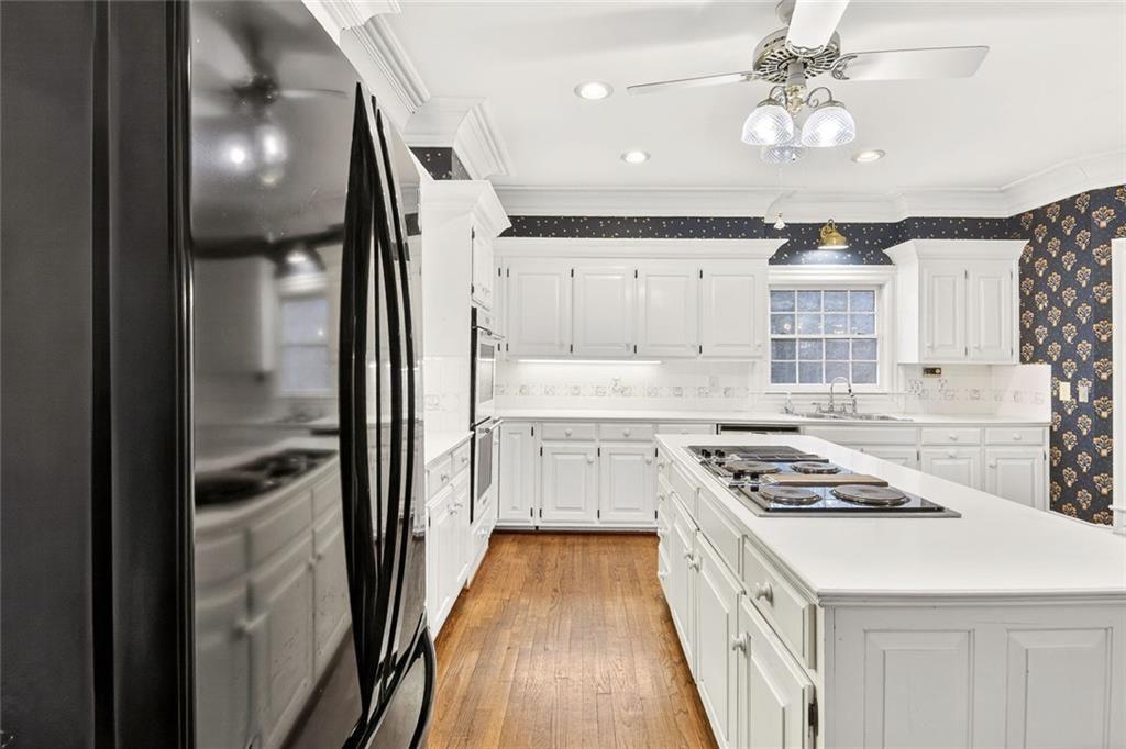 5523 Bahia Mar Circle Smoke Rise, GA 30087 - Photo 51 of 69 a kitchen with stainless steel appliances a refrigerator a sink dishwasher a stove and white cabinets