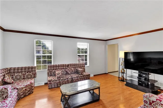 a view of a dining room with furniture and a window