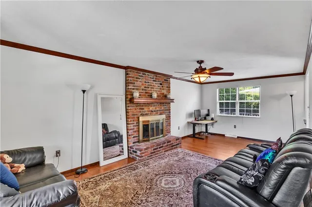 a living room with furniture fireplace and a window