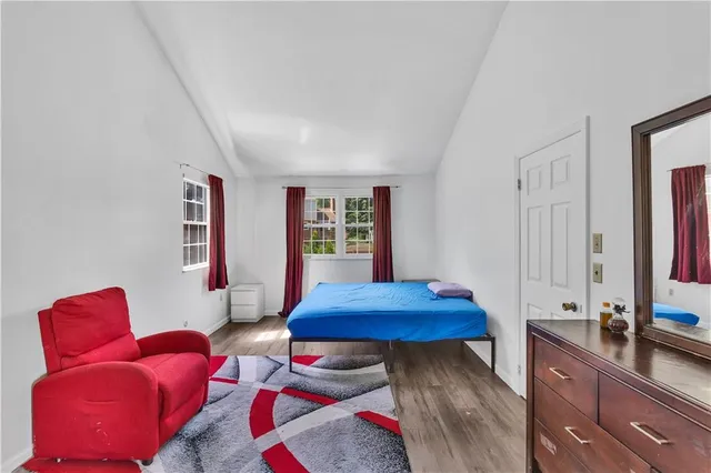 a bedroom with a bed and a dresser in it