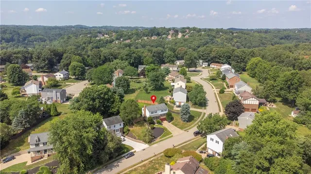 an aerial view of residential house with outdoor space and swimming pool