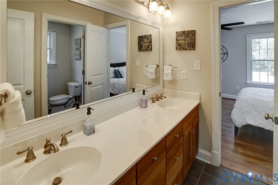 1295 Hermitage Road Manakin-Sabot, VA 23103 - Photo 48 of 55 a bathroom with a sink double vanity and a mirror