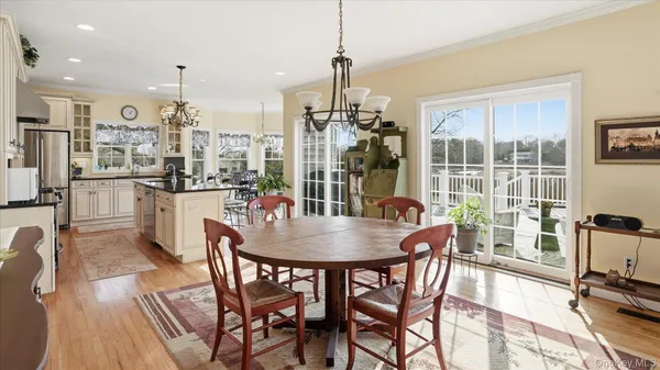 a dining room with furniture a chandelier and wooden floor