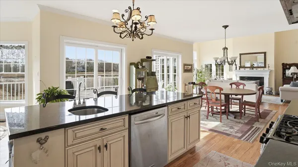 a kitchen with a counter space a sink dining table and chairs