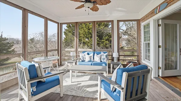 a living room with furniture and a floor to ceiling window