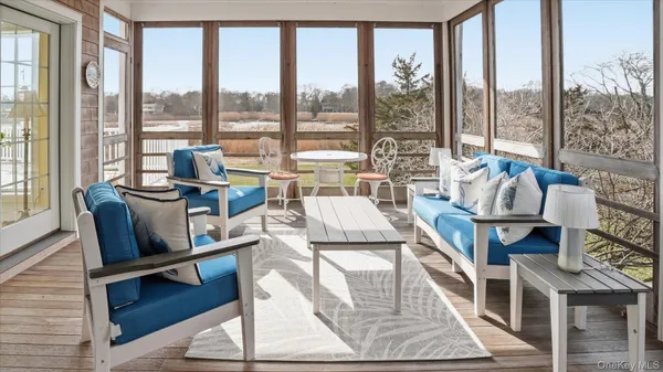 a living room with furniture and a floor to ceiling window