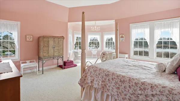 a bedroom with a bed and glass window