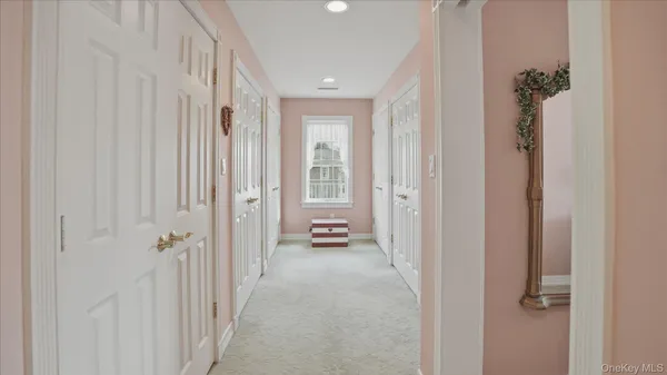 a view of a hallway with wooden floor and closet