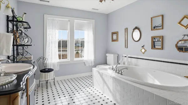 a bathroom with a bathtub a sink and a window